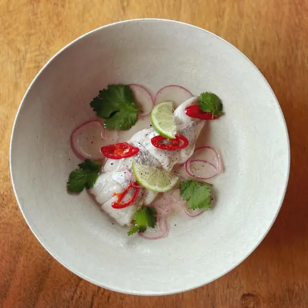Fresh local fish ceviche served at Volcanoview, garnished with lime, red chilli, coriander, and red onion, Taranaki restaurant dish.